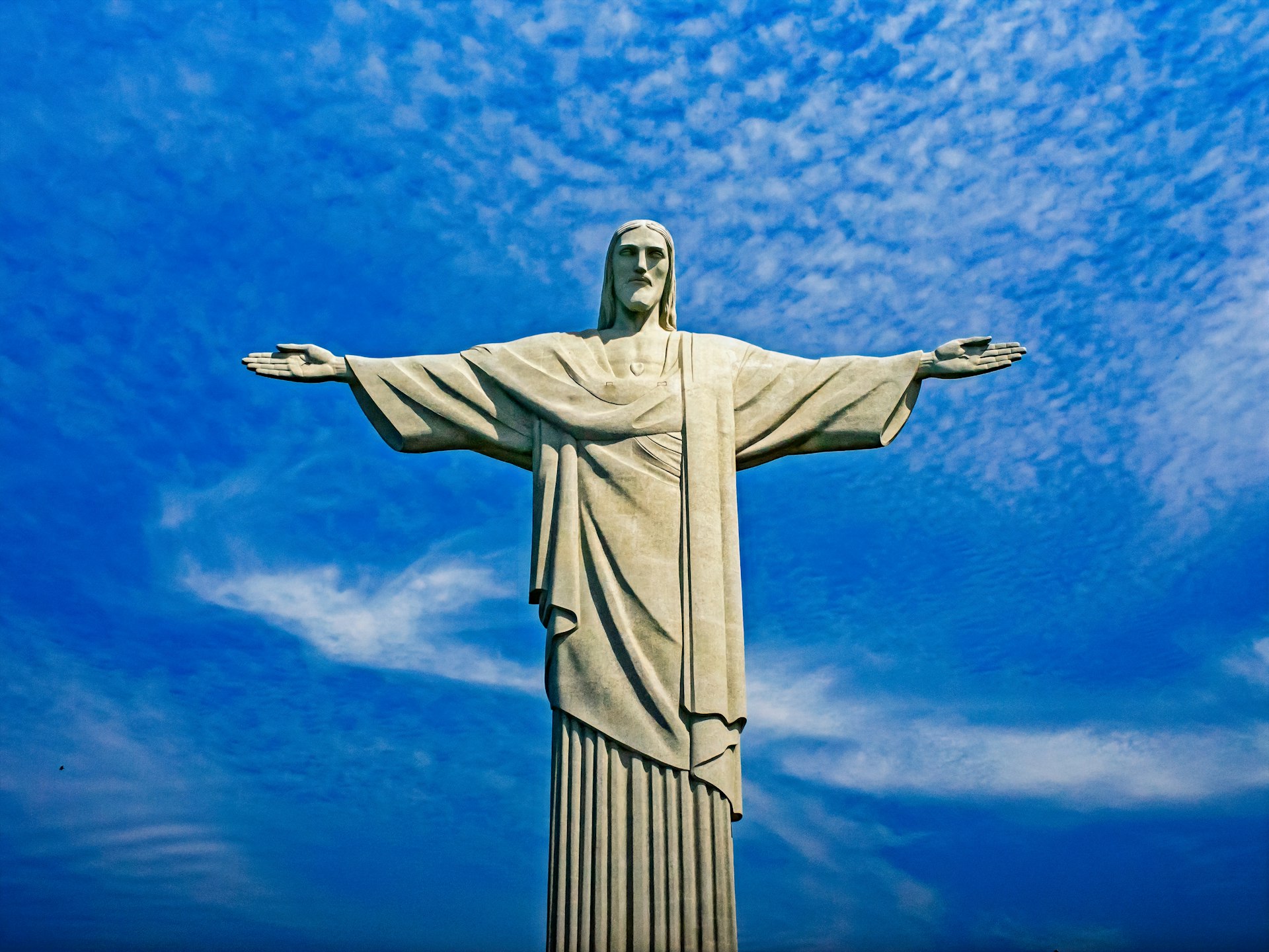 statue of Christ under blue sky during daytime