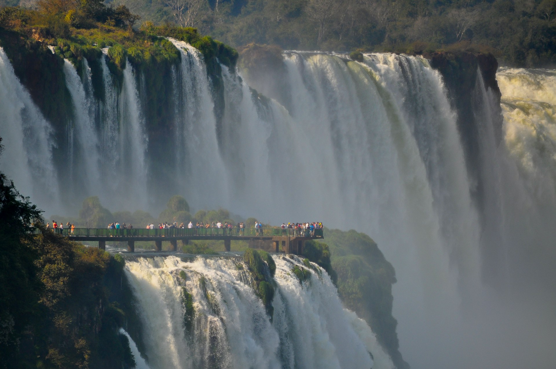 people looking at large waterfall